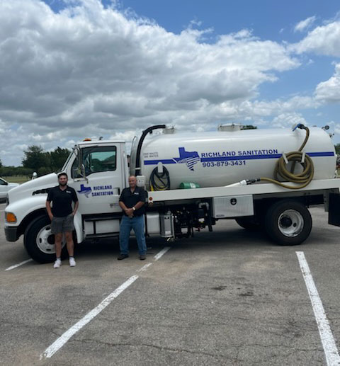 owners Jay and Westly in front of their company truck